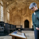 Close up person looking at old interpretation panel Divinity School