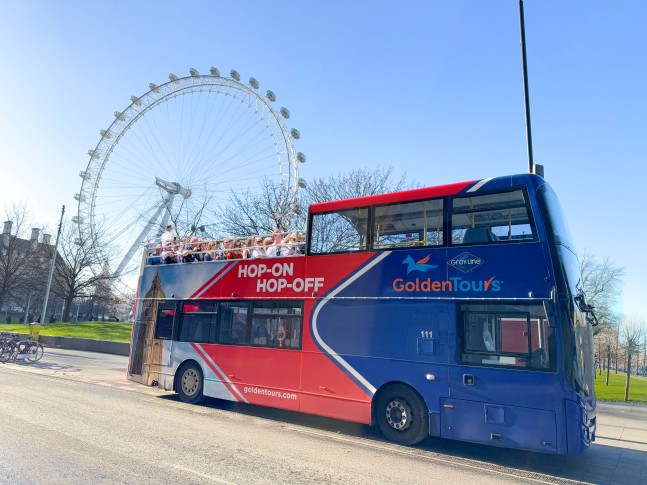 Golden Tours Hop-on Hop-off bus in front of the London Eye