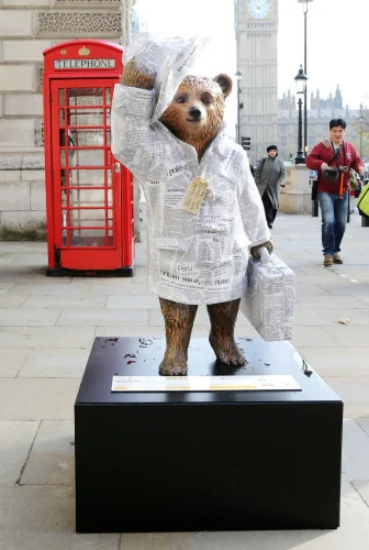 A photo of a statue of Paddington Bear in London.