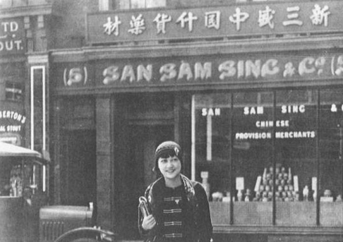 A young woman leaves a shop in Chinatown, Limehouse