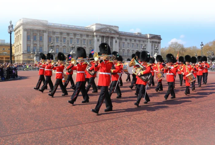 A photo of Beefeaters marching outside Buckingham Palace.