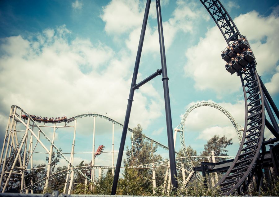 A photo showing a pair of roller coasters.